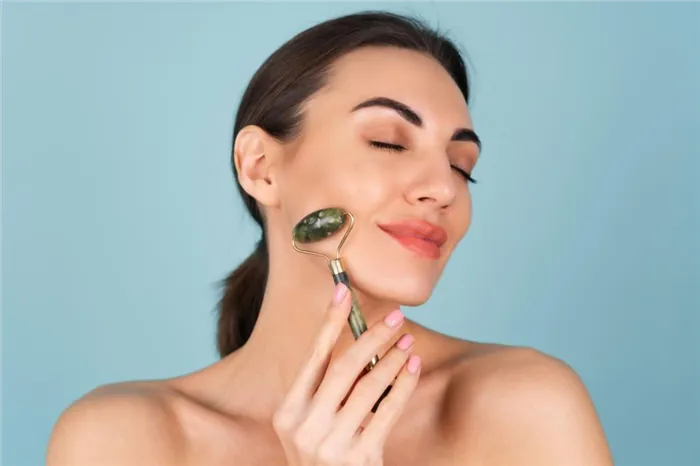 close-up-beauty-portrait-of-a-woman-with-perfect-skin-and-natural-make-up-plump-nude-lips-holding-a-roller-massager-for-face-and-neck (1).jpg